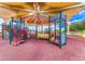 Colorful playground with castle-themed structures and sunshade, perfect for Gathering fun in a vibrant community park at 2853 Blythswood Sq, Henderson, NV 89044