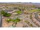 Expansive aerial view of community, golf course, pools, clubhouse, and mountain backdrop at 3017 Walnut Park Ct, Henderson, NV 89052