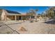 Expansive backyard with rock landscaping, mature trees, and a covered patio area at 3017 Walnut Park Ct, Henderson, NV 89052