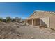 View of the backyard with rock landscaping, a covered patio, and the exterior of the home at 3017 Walnut Park Ct, Henderson, NV 89052