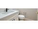 Close-up of a bathroom vanity with a white countertop, black faucet, and a white toilet at 3017 Walnut Park Ct, Henderson, NV 89052