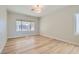 Bright bedroom with wood-look floors and a large window view at 3017 Walnut Park Ct, Henderson, NV 89052