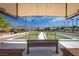 A covered bocce ball court and seating area at 3017 Walnut Park Ct, Henderson, NV 89052
