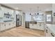 Bright kitchen showcasing white cabinets, stainless steel appliances, and a large island with sink and quartz countertop at 3017 Walnut Park Ct, Henderson, NV 89052