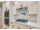 Well-equipped kitchen with stainless steel appliances, a gas cooktop, and modern white cabinets at 3017 Walnut Park Ct, Henderson, NV 89052