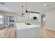 Open-concept kitchen with a large island, modern pendant lighting, and white cabinets at 3017 Walnut Park Ct, Henderson, NV 89052