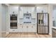 Modern kitchen featuring stainless steel appliances, white cabinets, and a built-in double oven at 3017 Walnut Park Ct, Henderson, NV 89052