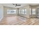 Bright living room with multiple windows, providing natural light, and wood-look flooring at 3017 Walnut Park Ct, Henderson, NV 89052