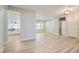 Living area with wood-look floors, recessed lighting, and views into kitchen and other rooms at 3017 Walnut Park Ct, Henderson, NV 89052