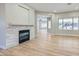 Living room featuring a modern fireplace, wood-look floors, and a view into other rooms at 3017 Walnut Park Ct, Henderson, NV 89052