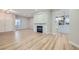 Spacious living room with wood-look flooring, a modern fireplace, and an open floor plan at 3017 Walnut Park Ct, Henderson, NV 89052