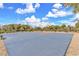 Community basketball court with blue playing surface, nestled amongst trees and shrubs at 309 Gemstone Hill Ave, North Las Vegas, NV 89031