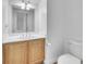 Bright bathroom featuring a wooden vanity, white countertop and neutral wall color at 309 Gemstone Hill Ave, North Las Vegas, NV 89031