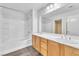 Bright bathroom with double sink vanity, tub, shower, and modern fixtures at 309 Gemstone Hill Ave, North Las Vegas, NV 89031