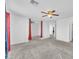 Open concept bedroom with grey carpet, modern ceiling fan and views to another room at 309 Gemstone Hill Ave, North Las Vegas, NV 89031