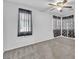 Bedroom featuring a ceiling fan, window with blinds and decorative curtains, and carpeted floor at 309 Gemstone Hill Ave, North Las Vegas, NV 89031