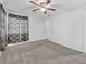 Bedroom featuring a ceiling fan, window with blinds and decorative curtains, and carpeted floor at 309 Gemstone Hill Ave, North Las Vegas, NV 89031