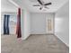 A spacious bedroom featuring grey carpet, white walls, and a glass door to the outside at 309 Gemstone Hill Ave, North Las Vegas, NV 89031