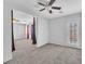 Large, neutral bedroom with a glass door to the outside and views of the adjacent room at 309 Gemstone Hill Ave, North Las Vegas, NV 89031