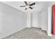 Comfortable bedroom featuring neutral carpet, white walls, natural lighting, and ceiling fan at 309 Gemstone Hill Ave, North Las Vegas, NV 89031