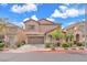 Charming two-story home featuring neutral stucco, an attached two-car garage, and well-maintained landscaping at 309 Gemstone Hill Ave, North Las Vegas, NV 89031