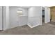 Upstairs hallway featuring neutral carpet, white walls, a window, and white railings at 309 Gemstone Hill Ave, North Las Vegas, NV 89031