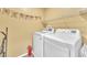 Laundry room featuring a new washer and dryer, with shelving and ample space at 309 Gemstone Hill Ave, North Las Vegas, NV 89031