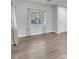 Bright living room featuring wood-look floors, neutral walls, and lots of natural light at 309 Gemstone Hill Ave, North Las Vegas, NV 89031