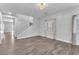 Open-concept living area with neutral walls, wood-look flooring, and a staircase leading to the upper level at 309 Gemstone Hill Ave, North Las Vegas, NV 89031