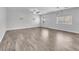 Bright and spacious living room featuring wood-look floors and large windows at 309 Gemstone Hill Ave, North Las Vegas, NV 89031