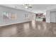 Spacious living room featuring wood-look floors open to the kitchen with a center island at 309 Gemstone Hill Ave, North Las Vegas, NV 89031