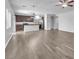 Spacious living room and kitchen featuring wood-look floors and neutral paint at 309 Gemstone Hill Ave, North Las Vegas, NV 89031