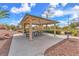 Community picnic shelter with metal roof, picnic tables, and grill in an outdoor setting at 309 Gemstone Hill Ave, North Las Vegas, NV 89031