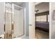 Bathroom featuring a glass enclosed shower, tile surround, and updated shower head at 3360 Cheltenham St, Las Vegas, NV 89129