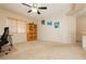 Open bedroom with large window, carpeted floors, ceiling fan, and wooden bookcase at 3360 Cheltenham St, Las Vegas, NV 89129
