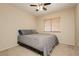 Neutral bedroom features a queen-sized bed, ceiling fan, and a window that provides natural light at 3360 Cheltenham St, Las Vegas, NV 89129