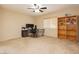Bedroom featuring carpeted floors, ceiling fan, and a large wooden bookcase at 3360 Cheltenham St, Las Vegas, NV 89129