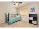 Bright bedroom featuring a ceiling fan, window with blinds, and a black bookcase against neutral walls at 3360 Cheltenham St, Las Vegas, NV 89129