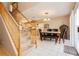 Bright dining area adjacent to the staircase with tile flooring and modern chandelier at 3360 Cheltenham St, Las Vegas, NV 89129