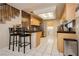 Well-lit kitchen with tiled floors, modern appliances, and a breakfast bar at 3360 Cheltenham St, Las Vegas, NV 89129
