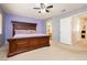 Spacious main bedroom with carpeted floors and a large wooden bed frame at 3360 Cheltenham St, Las Vegas, NV 89129