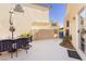 Back patio with outdoor dining set and landscaping, perfect for entertaining or relaxing in the sun at 3360 Cheltenham St, Las Vegas, NV 89129