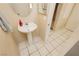 Small powder room with pedestal sink, large mirror, and neutral tile floors at 3360 Cheltenham St, Las Vegas, NV 89129