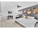 Comfortable bedroom featuring neutral carpet, fan, desk, and an accent wall at 3611 Valencia St, Las Vegas, NV 89121