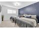 Cozy bedroom featuring two beds, star accent wall, and natural light at 3611 Valencia St, Las Vegas, NV 89121