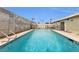 Inviting in-ground pool surrounded by a patio and secure fencing at 3611 Valencia St, Las Vegas, NV 89121