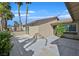 Private tiled backyard featuring a sliding glass door, exterior lighting, and mature landscaping at 3692 Rawhide Ct, Las Vegas, NV 89120