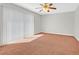 Cozy bedroom with carpet flooring, ceiling fan, and large window offering ample natural light at 3692 Rawhide Ct, Las Vegas, NV 89120