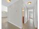 Neutral hallway with tile flooring leading to bathroom with vanity and open door to bedroom with large window at 3692 Rawhide Ct, Las Vegas, NV 89120