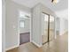 Hallway with neutral walls, tile flooring, and mirrored closet doors leading to bedroom with ceiling fan and window at 3692 Rawhide Ct, Las Vegas, NV 89120